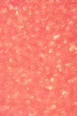 Abstrast blurred glittery shiny background, coral, colur of the year 2019
