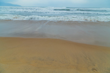Fototapeta na wymiar wave of blue ocean on Da Nang beach, Vietnam
