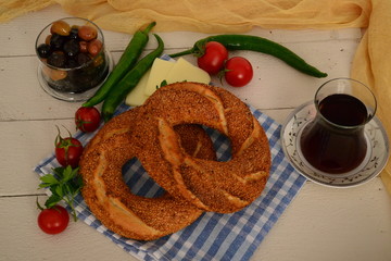 breakfast with tea  and bagels,tomatoes, olive,  pepper