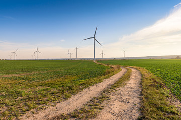 Windmills for electric power production surrounded by agricultural fields in Polish country side....