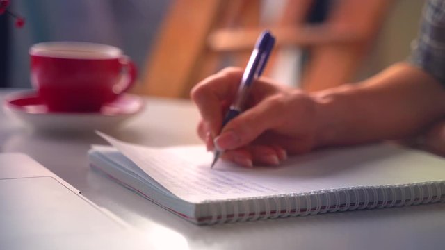 Young woman writes. Education 4k