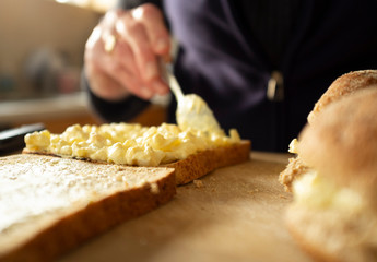 Woman making egg and onion sandwiches