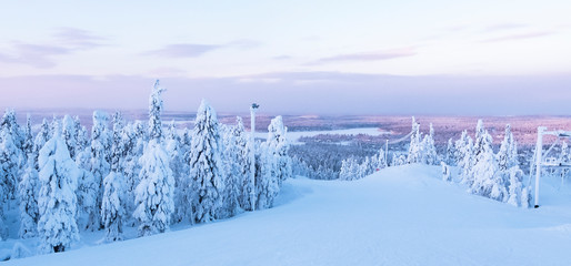 Snow-covered nature of Lapland, winter ski slope.