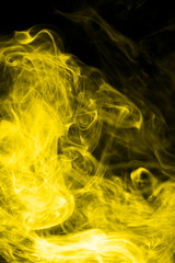 Yellow smoke on black background
