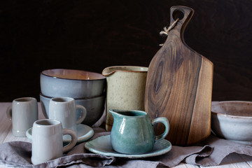 Collection of rustic simple handcraft kitchenware in neutral tones on grey background