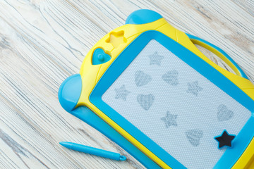 blue children's magnetic drawing board with pen. child's learning developing toy on the white background. background for a toy store Learning to draw