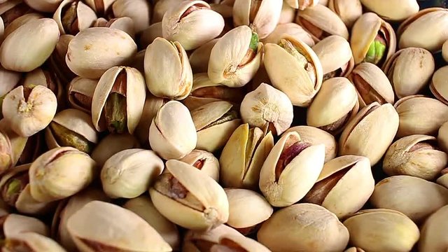 Pistachios pistachio nuts nut food closeup texture pattern seamless looping rotating video footage hd resolution.