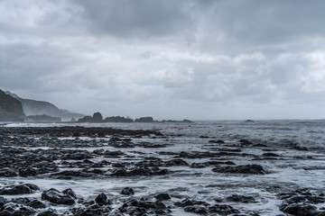 Fototapeta na wymiar great rocks on the beach of New Zealand, amazing rocks on the beach, rock texture background on the beach, New Zealand coastline with foggy weather 
