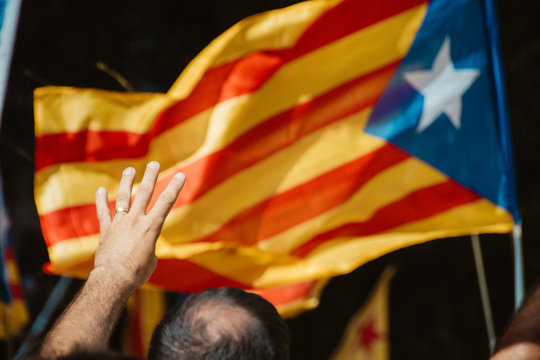People wave 'Esteladas' (pro-independence Catalan flags) as they gather during a pro-independence demonstration, on September 11, 2017 in Barcelona during the National Day of Catalonia, the 'Diada'.