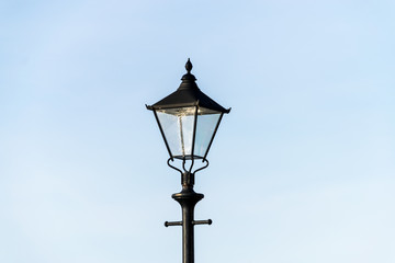 Fototapeta na wymiar old street lamp on blue sky background