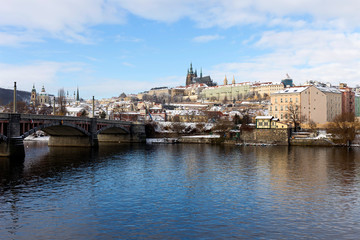 Snowy Prague Lesser Town with Prague Castle above River Vltava in the sunny Day, Czech republic