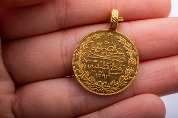 Turkish Ottoman style gold coin in hand