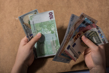 Hand holding American dollar  isolated on wooden background
