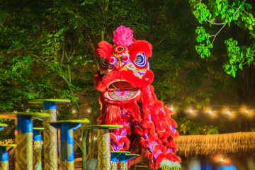 Awesome Chinese lion dancing shows on the poles at night during Chinese new year festival in...