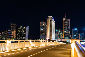 Fototapeta na wymiar Crossing the bridge against the background of lighting skyscrapers