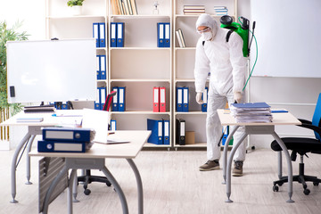 Professional contractor doing pest control at office