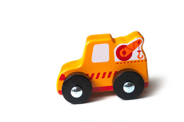 closeup of miniature wooden tow truck on white background - concept help on the road