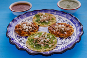 chalupas poblanas, mexican food Puebla Mexico on a blue background