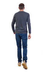 Naklejka premium Back view of going handsome man .