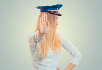 Woman standing with outstretched hand showing stop, no gesture.