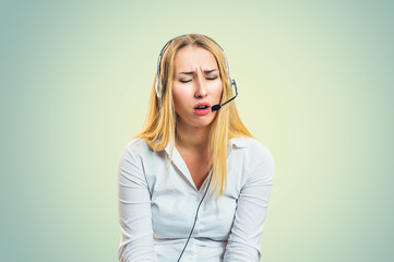 Woman in headset annoyed upset sad looking down eyes closed