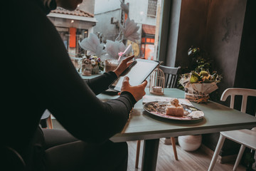 Girl typing on laptop and drinking coffee