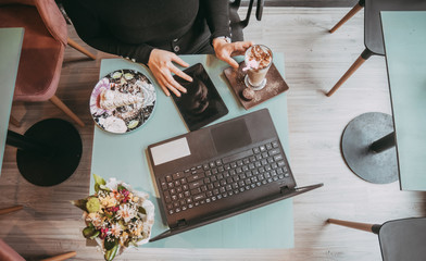 Girl typing on laptop and drinking coffee