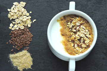 Healthy breakfast with white yogurt or kefir with flax seeds, oatmeal and bran. Superfood Fermented...