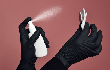 Doctor cosmetician keeps in hands bottle with spray dispenser and cotton pad