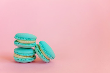 Sweet almond colorful unicorn blue macaron or macaroon dessert cake isolated on trendy pink pastel background. French sweet cookie. Minimal food bakery concept. Copy space