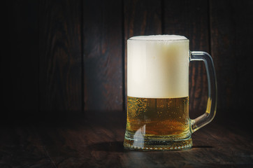 glass of beer on wooden background