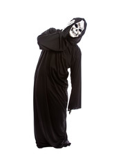 Halloween costume of a skeleton grim reaper wearing a black robe on a white background acting like...