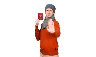 The Caucasian man with the international passport of the Russian Federation in warm clothes. Holds the opened palm before itself, the gesture - an appeal will stop