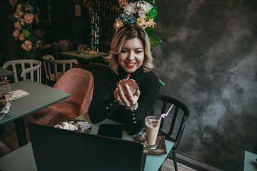 Girl typing on laptop and drinking coffee