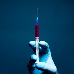 Beauty injection concept. Syringe with violet liquid for hypodermic injection.