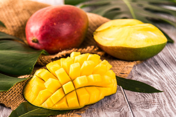 Mango. Tropical Fruits. On a wooden background. Blurred background selective focus.