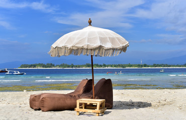 Sun umbrella with chair longue on tropical beach