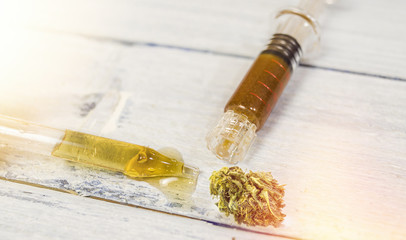 Bottle with CBD Cannabidiol, Cannabidiol full spectrum paste and hash on wooden table