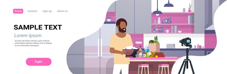 guy food blogger recording video on camera african american man preparing tasty dish modern kitchen interior cooking blog concept male character portrait flat copy space horizontal