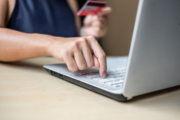 Businesswoman holding credit card  for online shopping while making orders via the Internet. business, technology, ecommerce and online payment concept