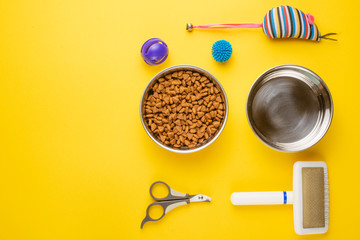 Pet, cat, food and accessories of cat life flat lay, with space for design, on yellow background