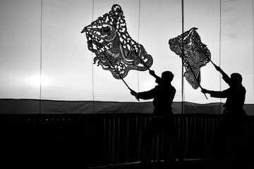 A group of people are playing an old Thai traditional shadow play called as Nang Yai,Composed to Black and White.