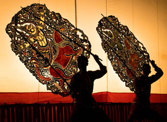 A group of people are playing an old Thai traditional shadow play called as Nang Yai,Composed to Golden tone.