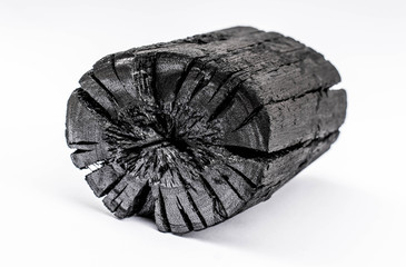 Black charcoal isolated on white background.