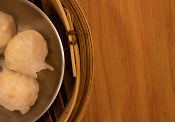 Flat lay steamed Chinese shrimp bonnet called as "Ha Gow" with blank space for text messages.