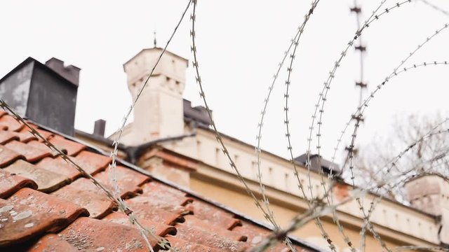Barbwire or NATO-fence shielding off a wall