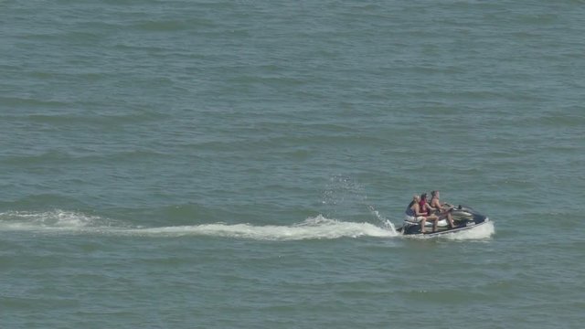 Jet ski moving past from left to right in slow motion.