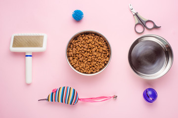 Pet, cat, food and accessories of cat's life flat lay, on a pink background. Background for design.
