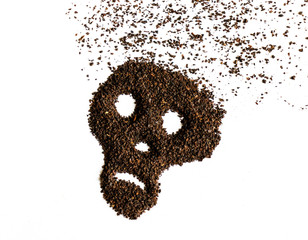 Skull shape made from dried tea leaves isolated on white background.