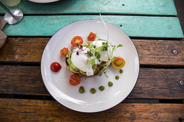 Smashed Avocado and Poached Eggs with cherry tomatoes